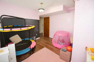 Rec room with wood finished floors and baseboards