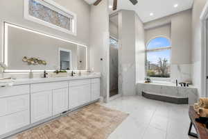 Bathroom with a garden tub, a marble finish shower, double vanity, recessed lighting, and ceiling fan