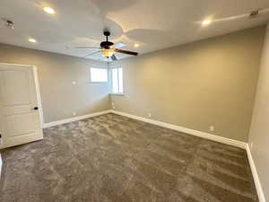 Spare room featuring recessed lighting, dark carpet, a textured ceiling, and ceiling fan