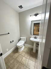 Bathroom featuring a textured ceiling and light tile patterned floors