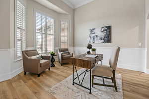 Office area with plenty of natural light, ornamental molding, and light wood-style flooring