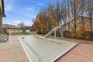View of swimming pool featuring a water slide and a patio area
