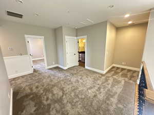 Empty room featuring carpet floors and a textured ceiling
