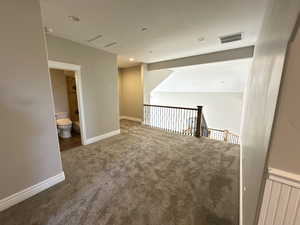 Hall with carpet flooring, recessed lighting, and an upstairs landing