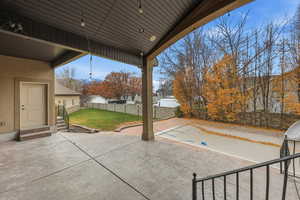Fenced backyard with a patio area and entry steps
