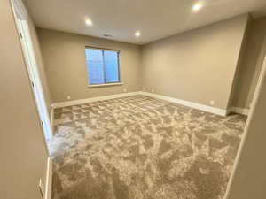 Unfurnished room featuring recessed lighting and carpet floors