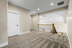 Empty room featuring recessed lighting and carpet