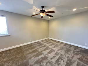 Unfurnished room featuring dark colored carpet, a textured ceiling, recessed lighting, and a ceiling fan