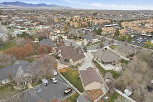 Aerial view of property and surrounding area with nearby suburban area and a mountain backdrop