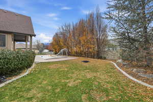 Fenced backyard with a patio area