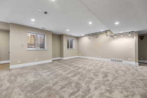 Below grade area with recessed lighting and light carpet