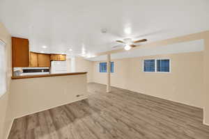 Unfurnished living room with light wood finished floors, recessed lighting, and a ceiling fan