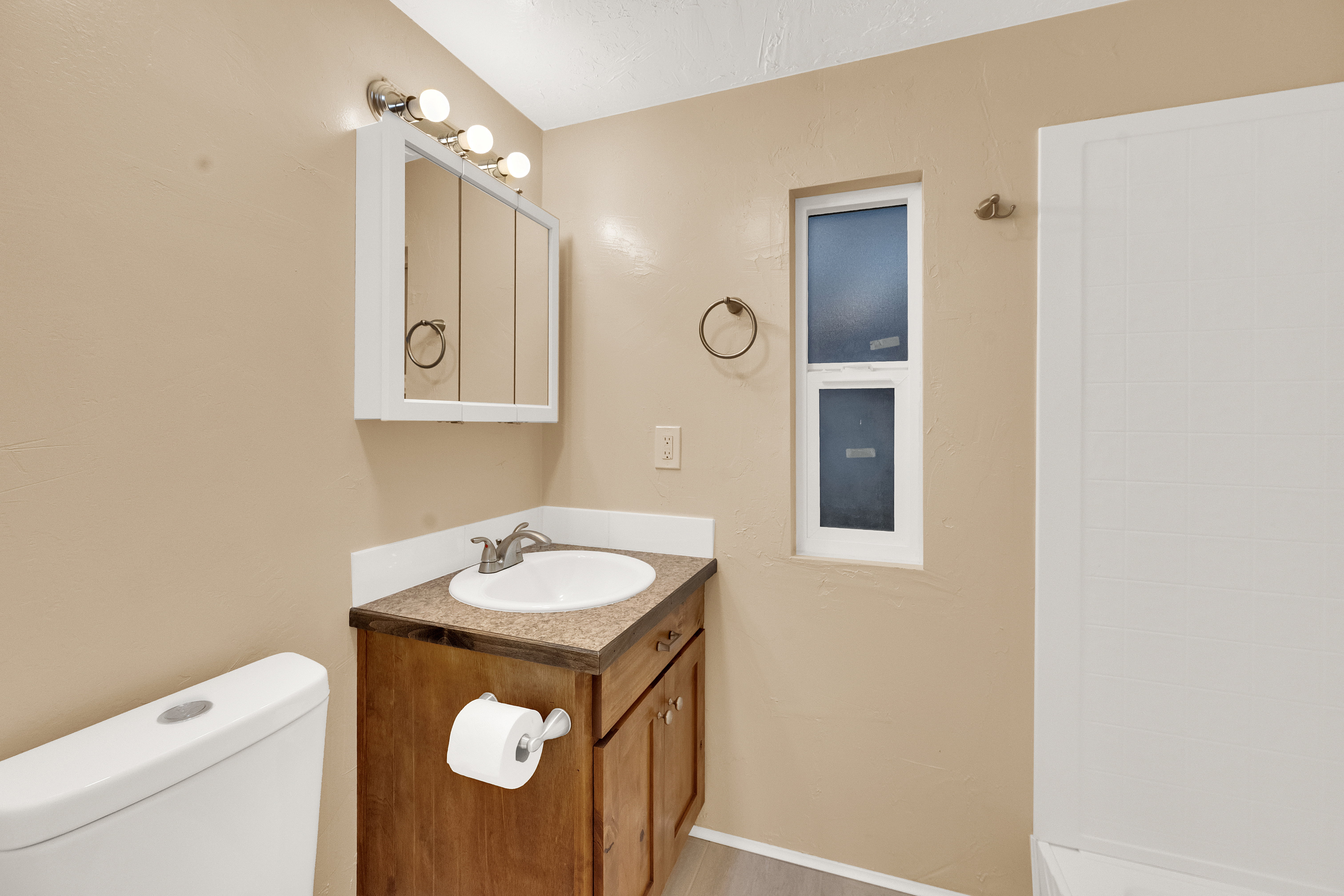 Bathroom featuring vanity and a shower