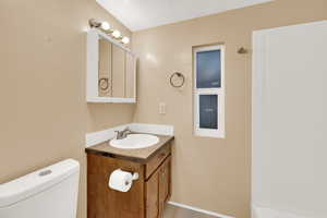 Bathroom featuring vanity and a shower