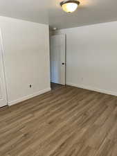 Spare room with dark wood-style flooring