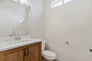 1/2 Bathroom with vanity and toilet