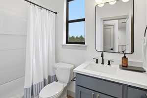 Full bathroom with vanity and shower / bath combo with shower curtain