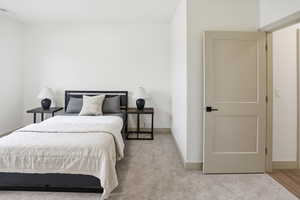 Bedroom featuring baseboards and carpet floors