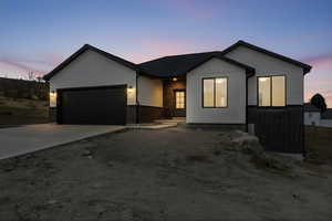 Ranch-style house with brick siding, concrete driveway, and an attached garage