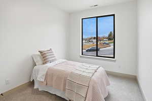Carpeted bedroom featuring baseboards