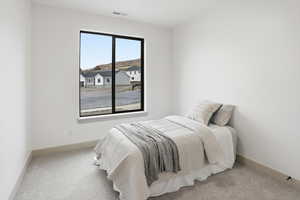 Carpeted bedroom featuring baseboards