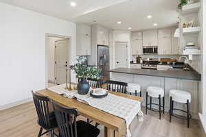 Dining area with recessed lighting and light wood-style floors