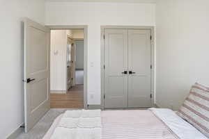 Bedroom featuring carpet floors and a closet
