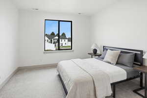 Bedroom featuring carpet and baseboards