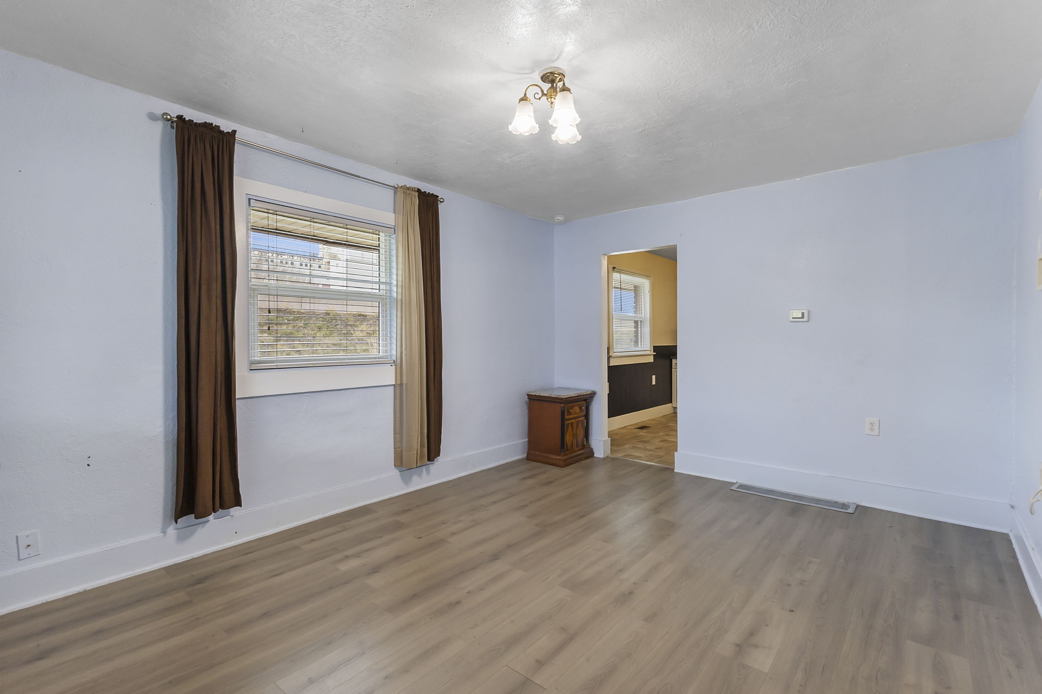 Unfurnished room with wood finished floors and a textured ceiling