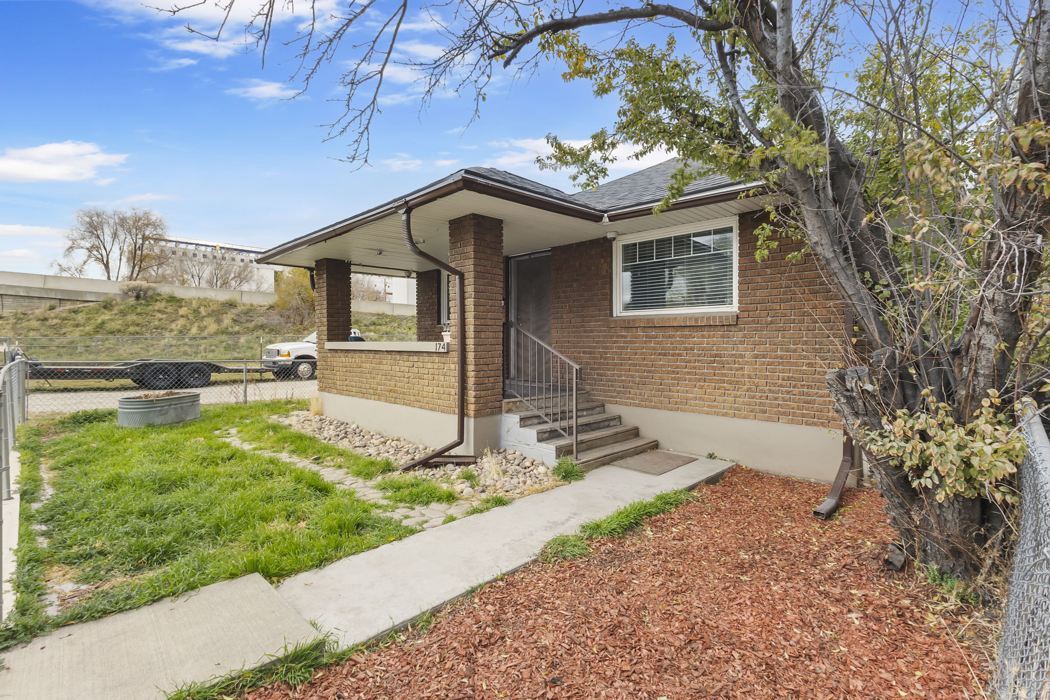 View of front of property with brick siding and roof with shingles