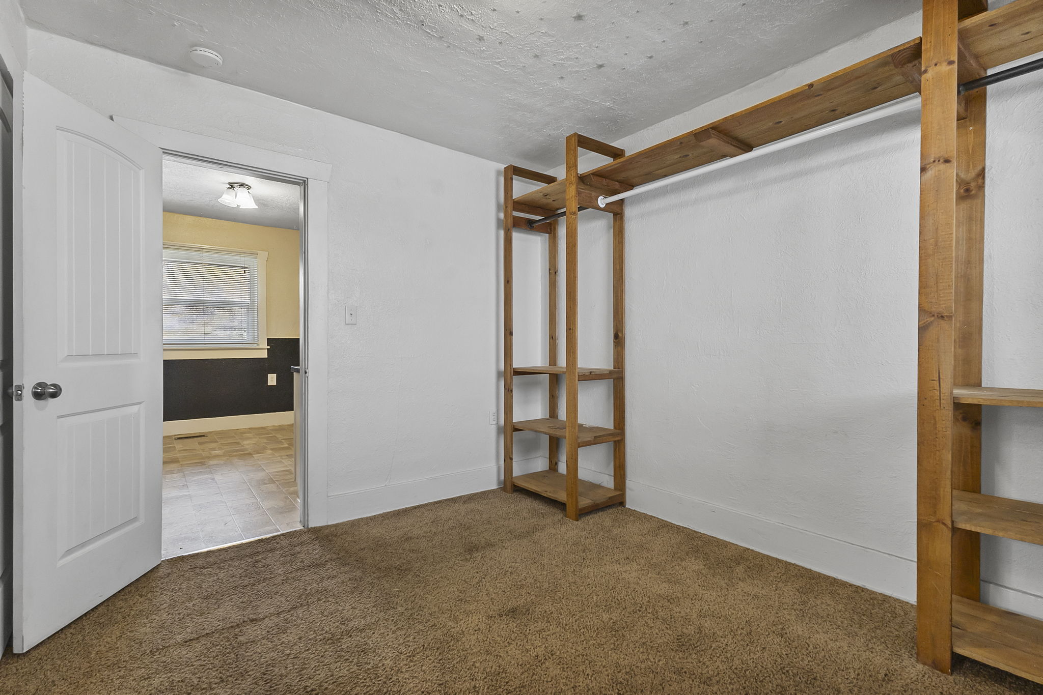 Unfurnished bedroom with carpet flooring and baseboards