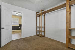 Unfurnished bedroom with carpet flooring and baseboards