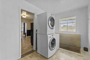 Laundry room featuring stacked washer / dryer