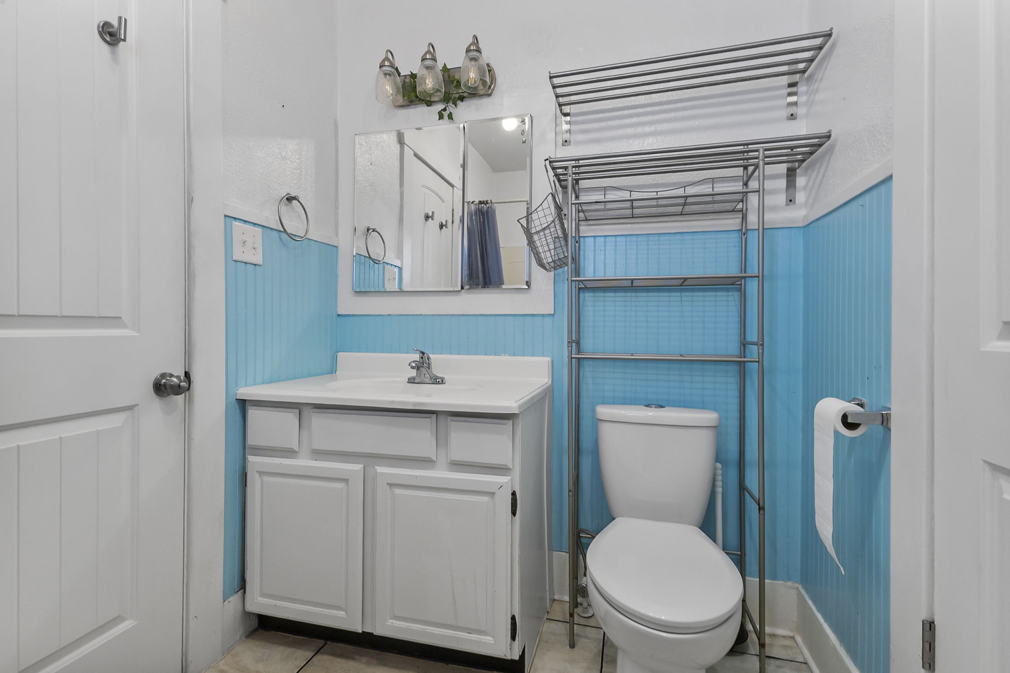 Bathroom featuring a shower with curtain, vanity, and light tile patterned floors