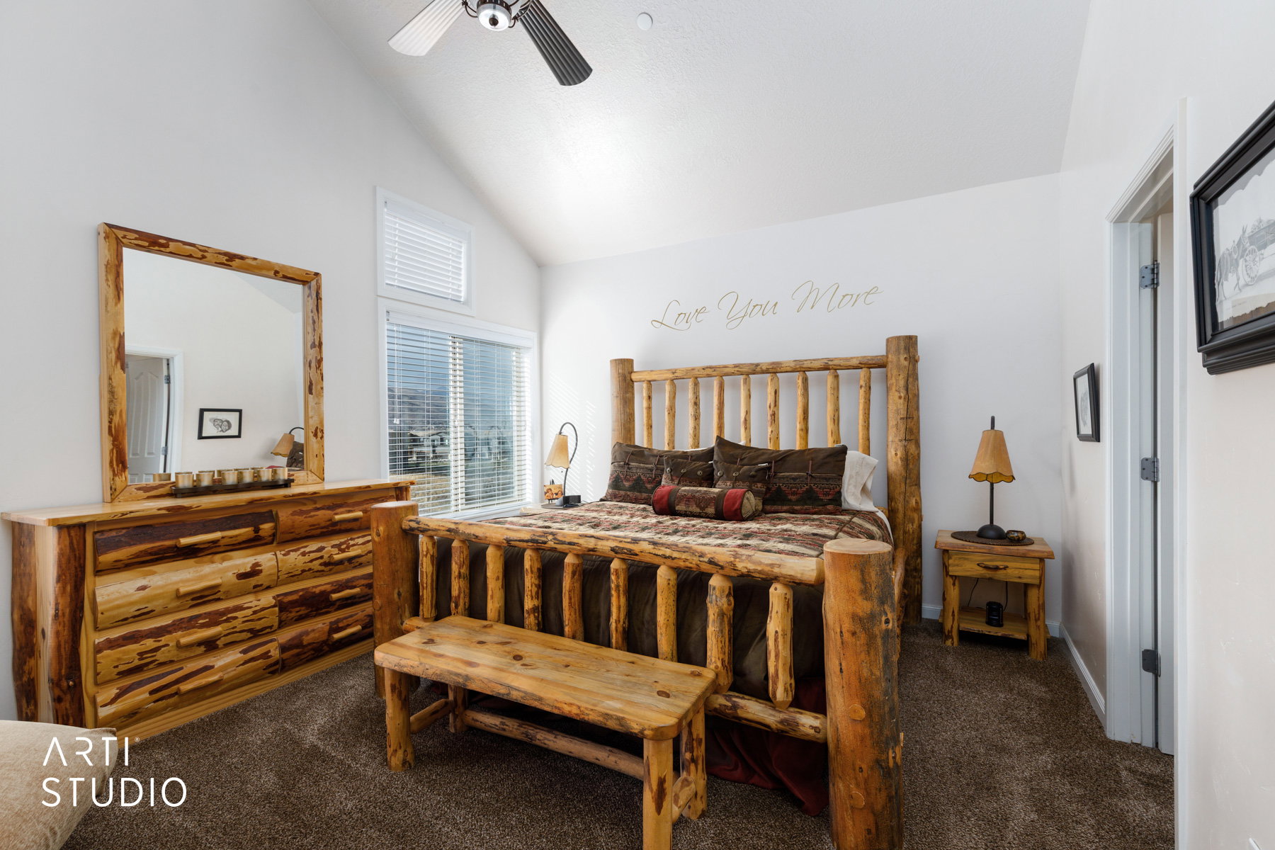 Carpeted bedroom featuring a ceiling fan and high vaulted ceiling