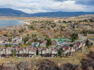 Aerial overview of property's location featuring nearby suburban area and a water and mountain view