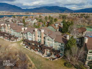 Aerial view of property's location featuring nearby suburban area and a water and mountain view