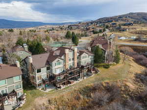 Aerial view of property's location with nearby suburban area and a mountainous background