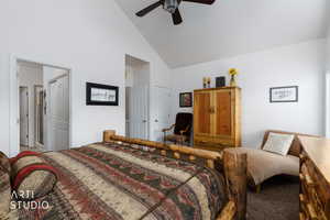 Carpeted bedroom featuring high vaulted ceiling, a closet, and a ceiling fan