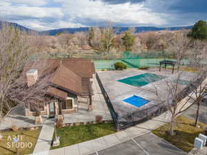 Community pool with a patio area and a mountain view