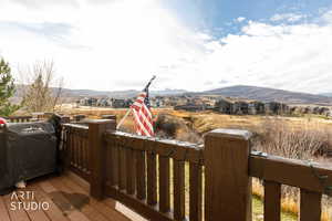 Deck with a mountain view, grilling area, and a residential view
