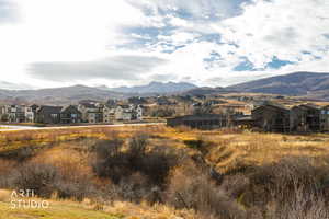 View of mountain backdrop featuring nearby suburban area
