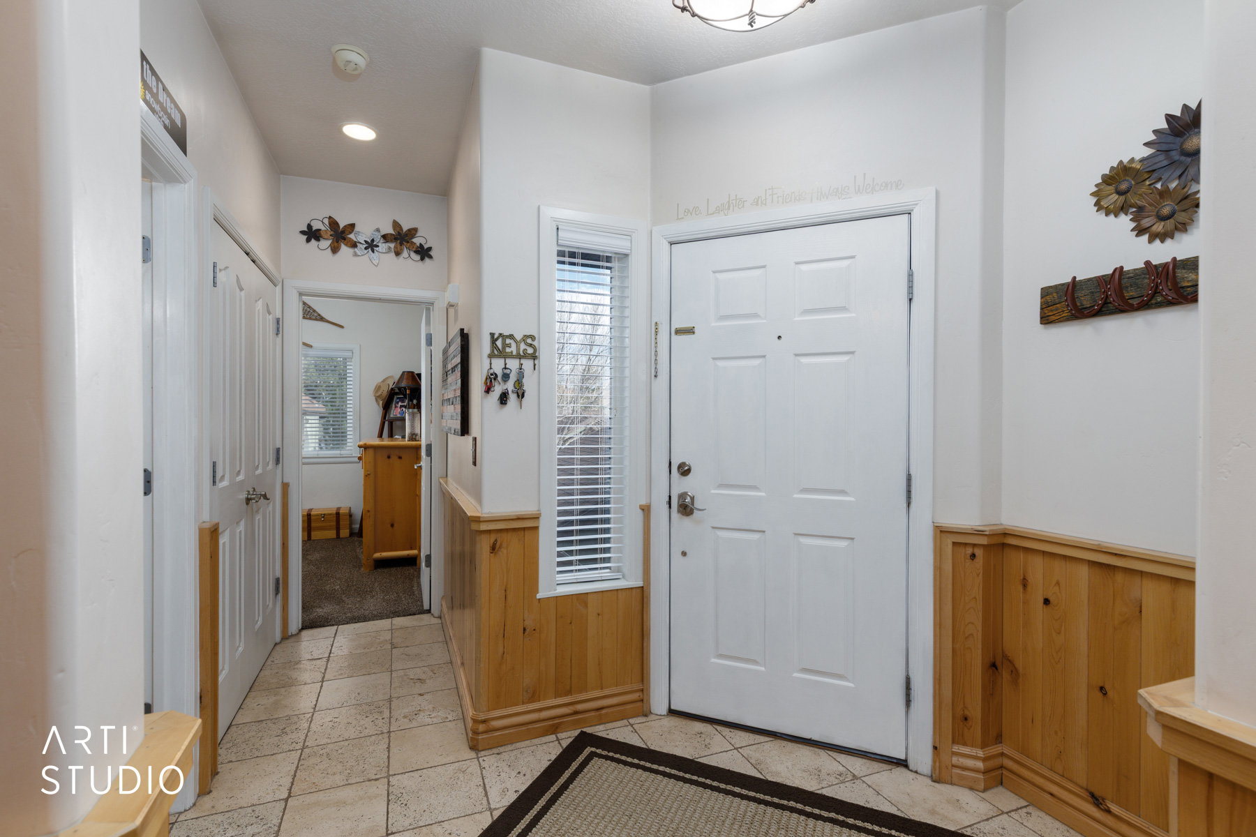 Foyer entrance featuring wood walls, a wainscoted wall, recessed lighting, and light tile patterned floors