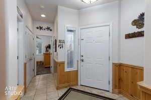 Foyer entrance featuring wood walls, a wainscoted wall, recessed lighting, and light tile patterned floors