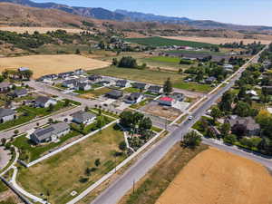 Aerial view of property's location with nearby suburban area and mountains
