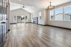 Unfurnished living room with light wood-type flooring, a ceiling fan, recessed lighting, and high vaulted ceiling