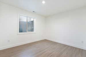 Spare room featuring wood finished floors and recessed lighting