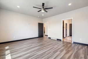 Spare room with light wood-style floors, recessed lighting, and a ceiling fan