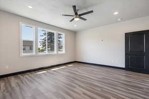 Empty room with light wood finished floors, recessed lighting, and a ceiling fan