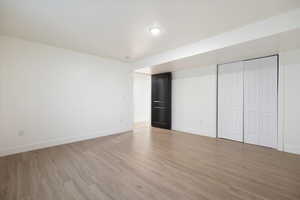 Unfurnished bedroom with light wood-type flooring and a closet